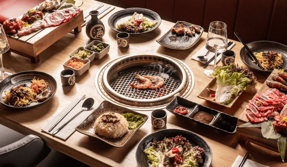 Interactive dining experience, grilling meats at the table.